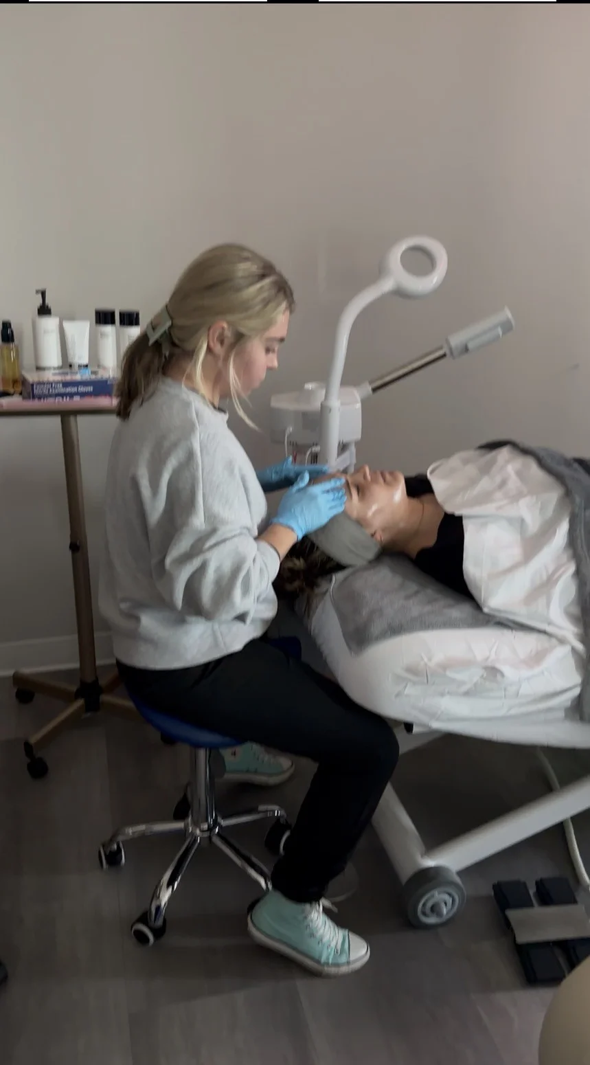 Student practicing facial treatment techniques